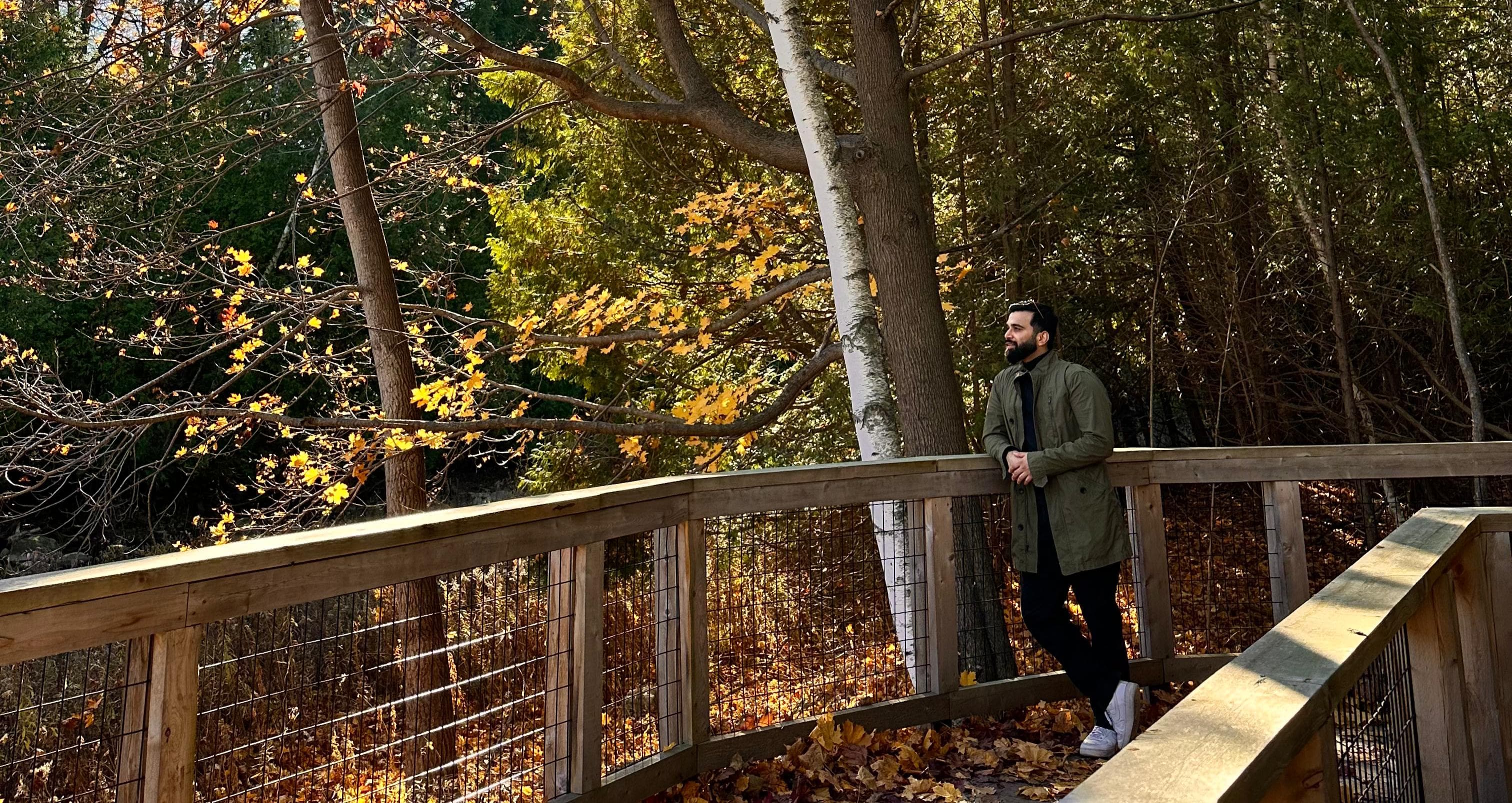 Aditya standing on a bridge